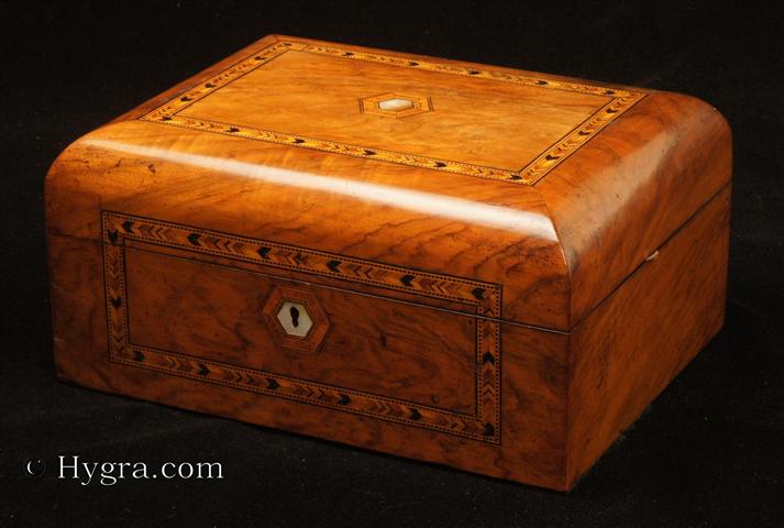 Antique inlaid figured walnut box with domed top opening to a ruched satin lined lid and a compartmentalized lift-out tray  fitted for sewing with supplementary lids Circa 1870. -Enlarge Picture